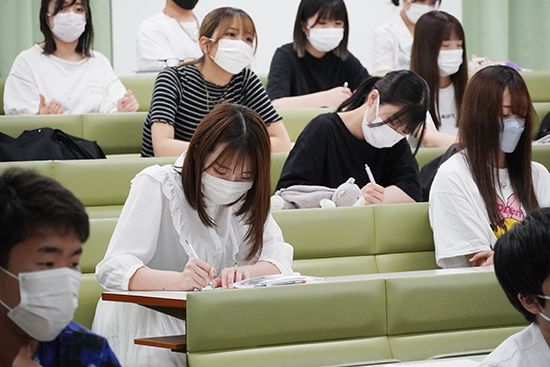 講義の内容をメモする学生たち